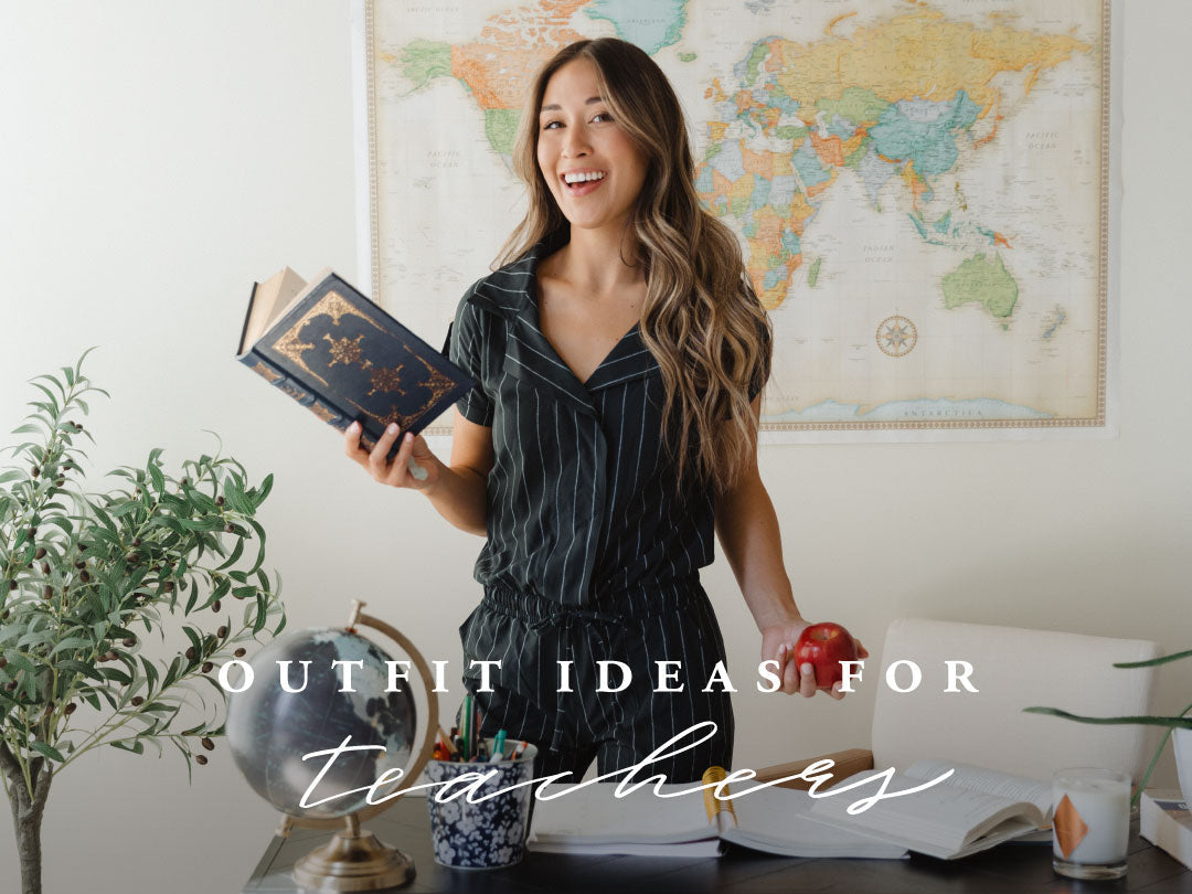 Outfit ideas for teachers: teacher in a black striped outfit holding a book in a classroom with a world map