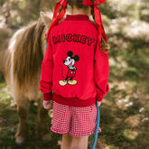 Child wearing Mickey Mouse jacket for kids with matching shorts.