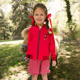 Child wearing a comfy and cute Disneyland outfit for kids—Disney jacket for kids and Disney shorts for kids.