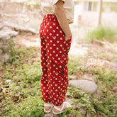 Close up of child in a garden wearing Minnie Mouse pants in red polka dot print
