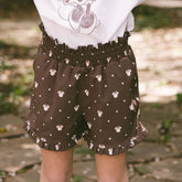 Close up of child wearing Minnie Mouse print shorts—the perfect subtle Disneyland outfit.