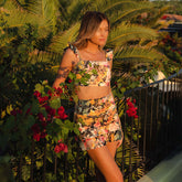 Front view of model wearing floral bathing suit with beautiful swim skirt