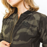 Woman wearing the Utah Camo Bomber Jacket showing a close up of the Utah logo in black