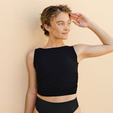 Model wearing black tankini top