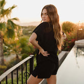 Back view of swim cover up outfit in black plush material