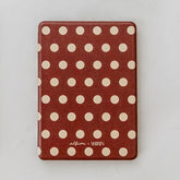 Polka dot tablet case with a visible brand logo on a white background