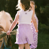 Close up back view of child wearing a kids Disney outfit in purple gingham.