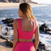 Close up back view of model wearing women's bikini in pink gingham