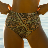Woman wearing brown zebra print bikini bottoms—mid rise swimsuit bottoms with flattering ruched sides.
