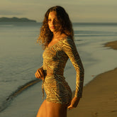Side view of woman wearing boy short bikini bottoms and swimsuit top in zebra print