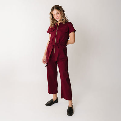Model wearing flattering womens jumpsuit with short sleeves and cropped pants and front zipper
