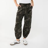 Close up front view of womens camo cargo pants in wrinkle free material