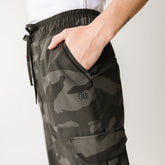 Close up details of cargo pants in camo with lots of pockets and stretchy waistband