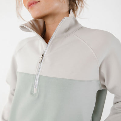 Close up view of two tone half zip sweatshirt