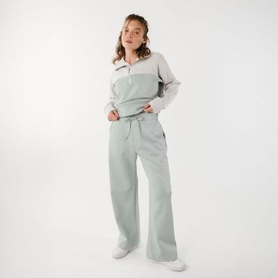 Front view of model wearing matching set with wide leg sweatpants and matching half zip sweatshirt