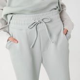 Close up front view of wide leg trouser sweat pants with thick waistband and adjustable tie and pockets