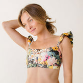 Close up of floral bathing suit top with ruffle sleeves