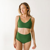 Front view of model wearing green bikini with high waisted bottoms in italian terry material