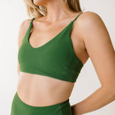 Close up view of women's bikini top in green terry cloth