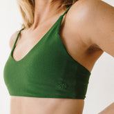 Close up of women's albion bikini top with green terry material