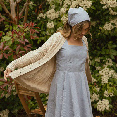 Model wearing blue bandana with cute blue seersucker dress.
