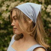 Model wearing cute blue bandana with matching blue seersucker dress.