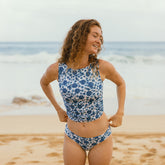 The most flattering tankini—model wearing blue floral tankini and low waist bikini bottoms.
