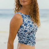 Close up view of blue floral tankini with flattering ruched side details highlighted.
