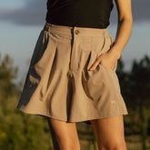 Casual women's shorts in wrinkle free material. Tan shorts with pockets and flattering pleats.
