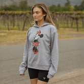Model wearing Disney inspired sweatshirt. Oversized grey hoodie with Minnie Mouse graphic sweatshirt.