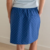 Back view of blue City Skirt showcasing blue polka-dot pattern and side pockets on a model against a neutral background