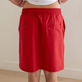 Back view of City Skirt showcasing two back pockets and elastic waistband with neutral indoor background