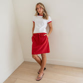 Front view of City Skirt, Red Polka Dot showcasing elastic drawstring waist and knee-length fit on model indoors