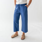 Front view of Audrey mid-rise wide-leg pants showcasing blue polka dot fabric and pockets against a light background