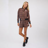 Front view of Disney Mickey Lake Shorts in brown plaid, showing Mickey patch and loose fit on model against a white studio background