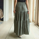 Woman wearing a green maxi skirt indoors