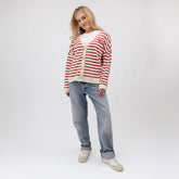 Front view of Utah Cardigan in red and white stripes showcasing button closure and U logo with model on a light background