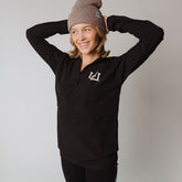 woman wearing a full zip jacket in black with Utah logo in white