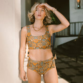 Model standing in doorway in two-piece midi bikini