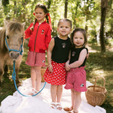 Three children wearing red and black Disney outfits for kids. 