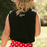 Close up back view of child wearing a Disney tank top for kids with Minnie's signature embroidered on the back 