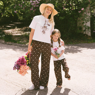 Woman and child standing together wearing cute matching outfits for Disneyland.