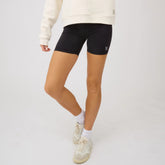 Front view of Disney Mickey biker shorts in black showing a fitted length on a model against a light gray background