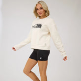 Three-quarter view of Disney Mickey black biker shorts showcasing a Mickey graphic and slim fit on a model against a light studio background