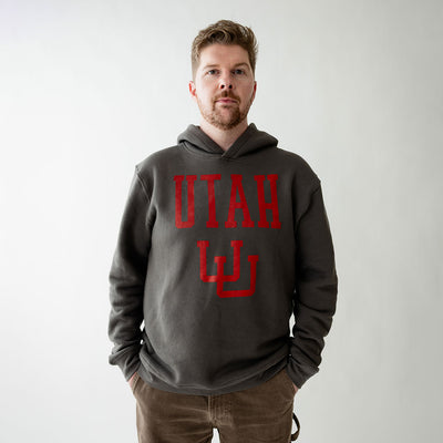 Man wearing a gray hoodie with 'UTAH' printed in red on a plain background
