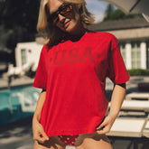 Woman wearing the perfect 4th of July shirt in red with monochrome USA in dark red.