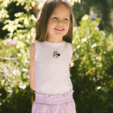 Young girl wearing a sleeveless top for kids with Minnie Mouse embroidery and checkered shorts in purple. 