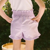 Back view of child wearing purple gingham shorts for kids that are the perfect Disneyland shorts. 