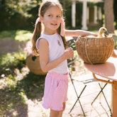 Young girl holding a wicker basket with baby ducks inside and wearing a Daisy Duck outfit for kids.