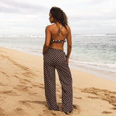 Woman in polka dot pants standing on a beach